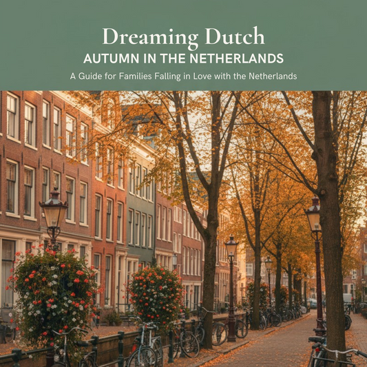 A book cover titled "Dreaming Dutch: Autumn in the Netherlands" with a photograph of a cobblestone canal street lined with bicycles, hanging flower baskets, and autumn trees, framed by muted green bands at the top and bottom.